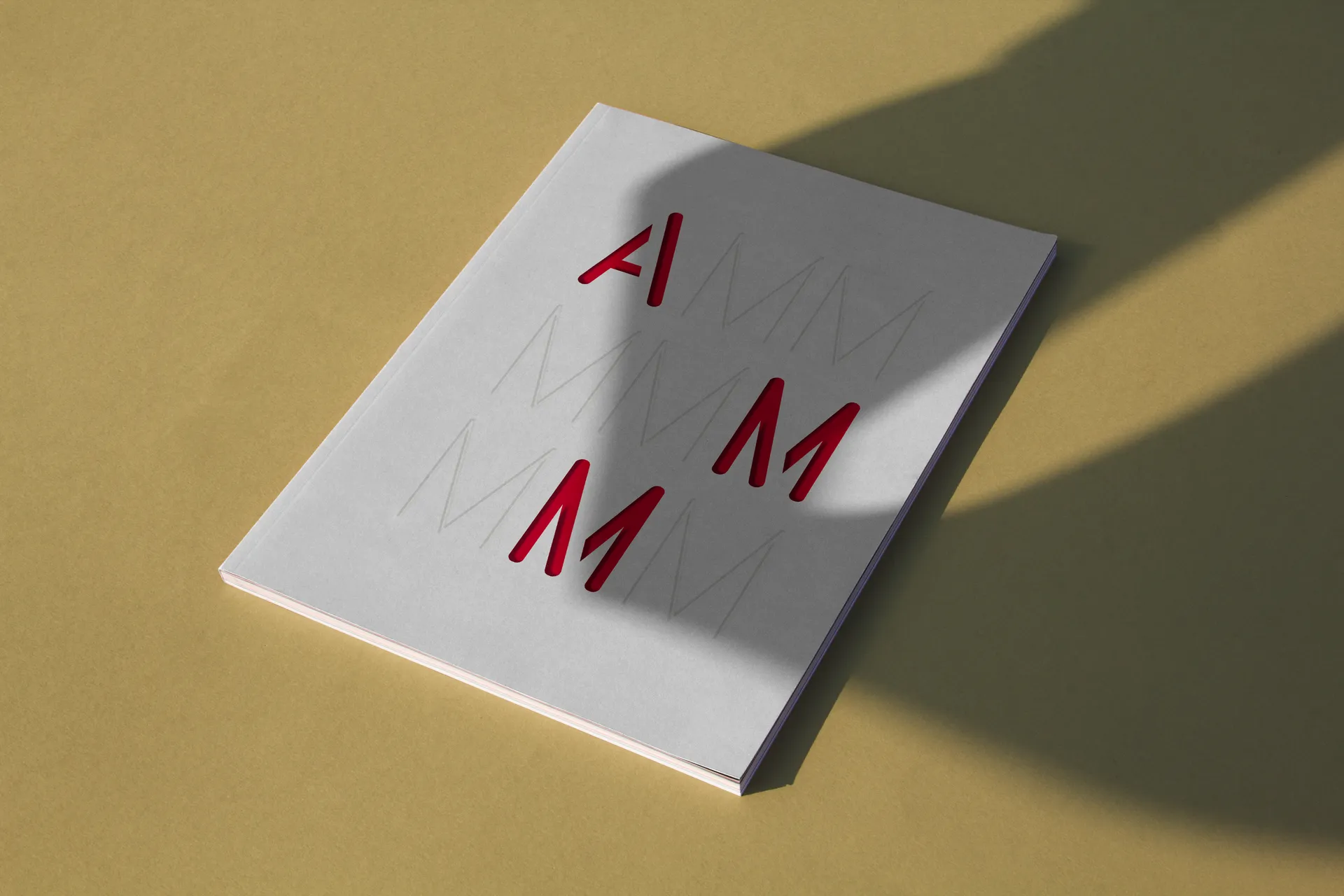 Livre conçu à l’occasion des 20 ans de l’agence d’architecture AMM, couverture blanche avec logo rouge en relief.